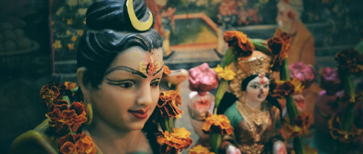 depth of field photo of diety god statuette